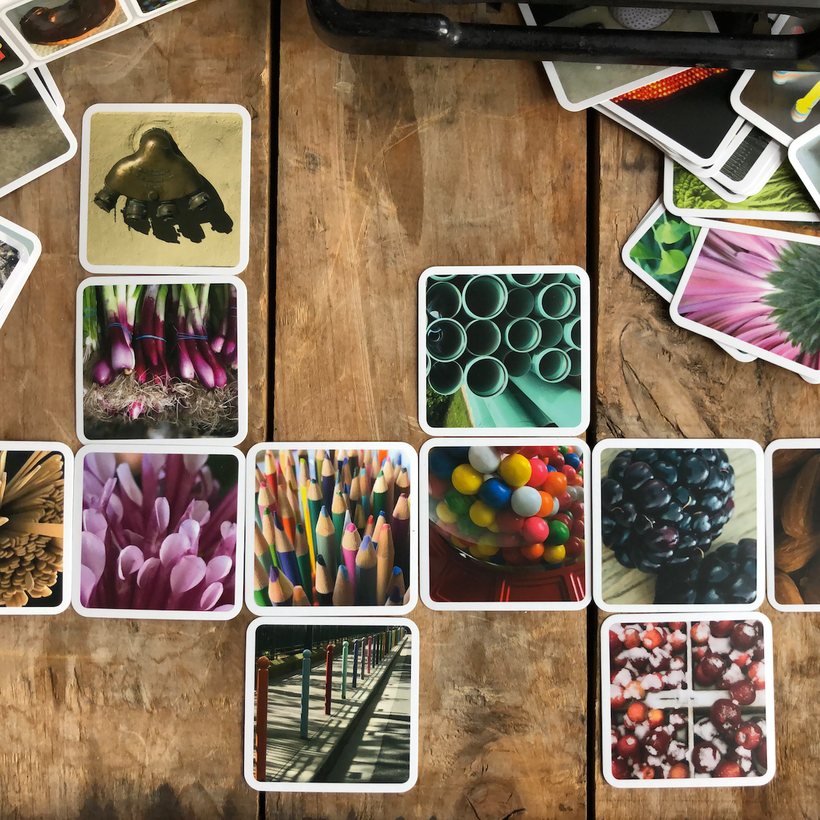 OuiSi cards arranged in a grid on a wooden table